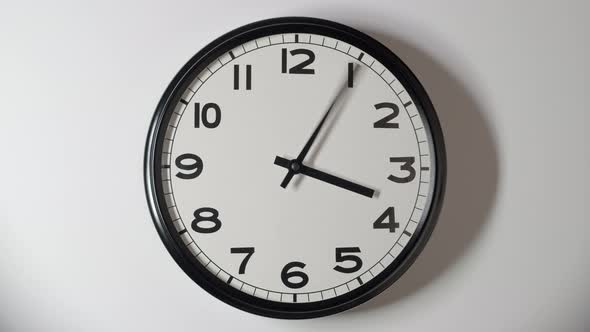 White Clock Face 3.1 Close Up in Time Lapse on White Wall in Office alt