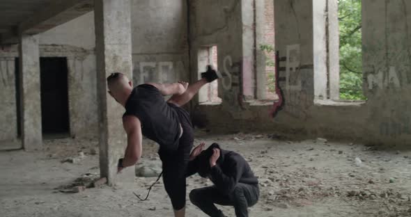 Two Angry Men Perform a Free Fighting with Skilled in an Abandoned Building alt