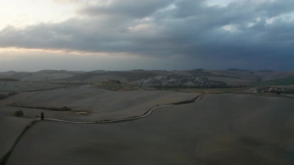 Aerial View of a Rural Landscape During Sunset in Tuscany. Rural Farm, Cypress Trees, Green Fields