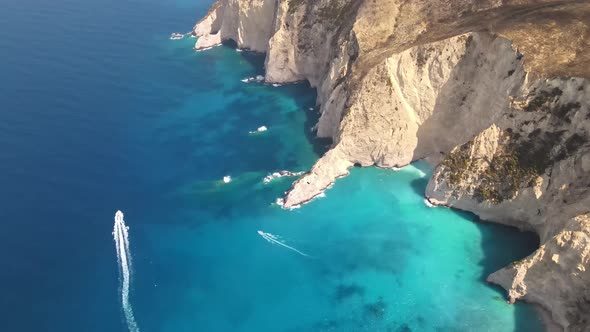 Aerial drone view of the Ionian Sea coast of Zakynthos, Greece. Rocky ridge, floating boats alt