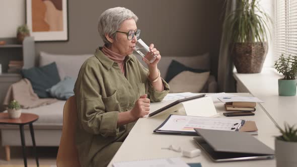 Senior Asian Woman Working at Home alt