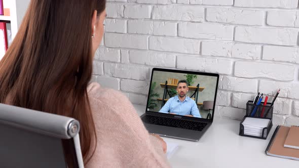 Man tutor in computer screen tells teaches by remote web cam, distance education alt