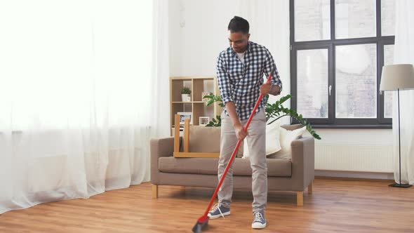 Indian Man with Broom Cleaning Floor at Home , Stock Footage | VideoHive
