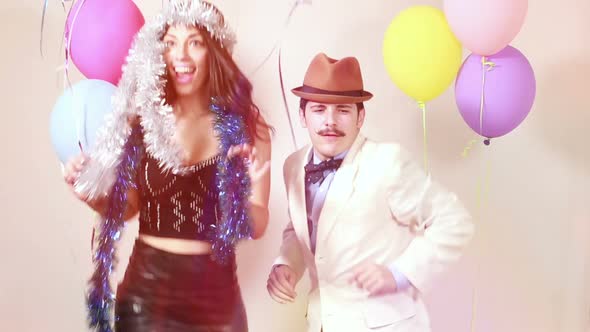 Slow motion of funny couple having fun in photo booth alt