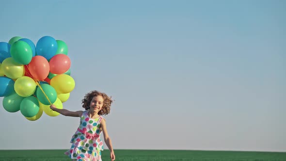 Happy Child Playing with Bright Multicolor Balloons 