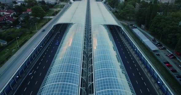 Aerial view on a highway with acoustic screens along. alt