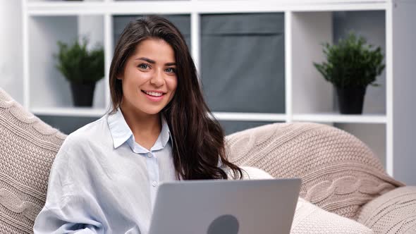 Portrait of Mixed Race Young Woman Posing Sitting on Couch with Laptop Pc alt