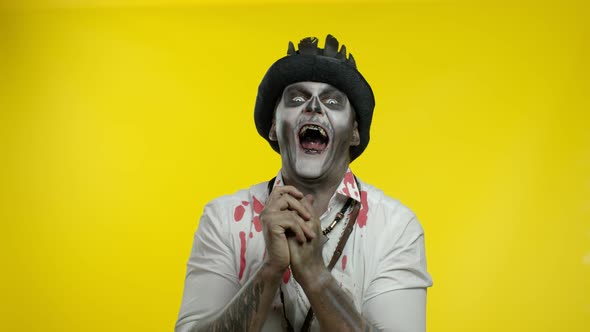 Man in Skeleton Halloween Costume. Cunning Guy in Creepy Makeup with Tricky Face Thinking Prank alt