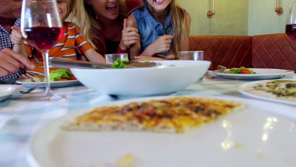 Family having meal together in restaurant 4k alt
