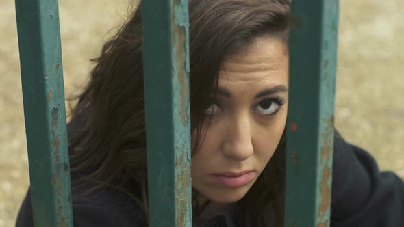 Captivity, Depression, Sadness - Young Woman Behind Bars alt