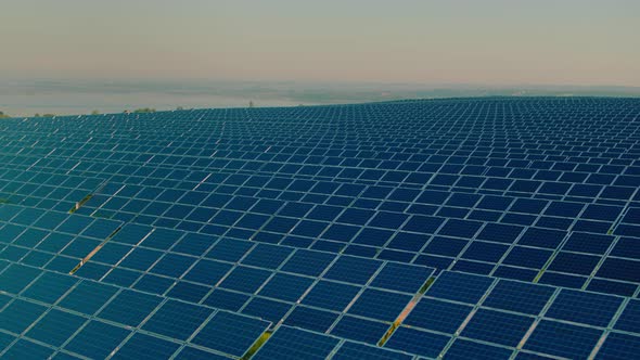 Hundreds of Solar Panels Arranged in Rows on Field alt