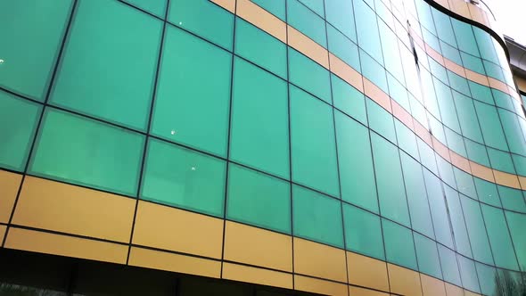 Modern design of a new greenand yellow architecture with glass mirror windows alt