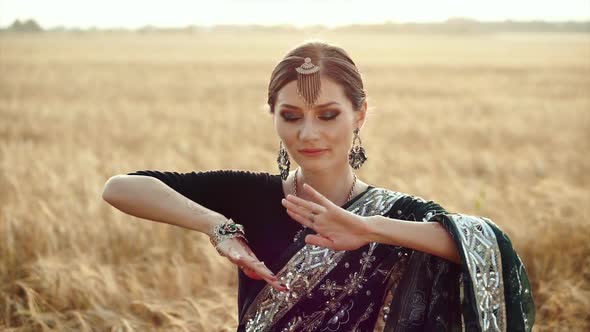 Silhouette of Beautiful Lady Wearing Gorgeous Traditional Dress Performing Bollywood Festival Show alt
