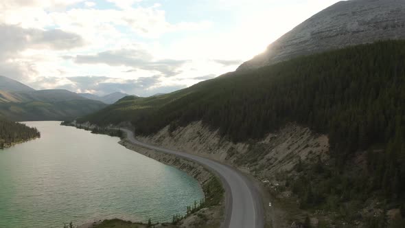 Gorgeous View of Glacial Lake and Scenic Road at Sunset alt