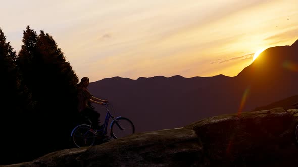 Young Woman Doing Mountain Tour by Bicycle at Sunset