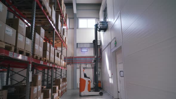 the Loader Lifts the Goods Onto the Warehouse Shelves