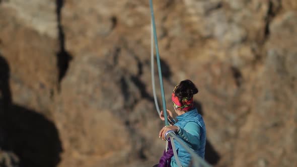 The Woman Climber Is Sent Up the Rope Across the Chasm