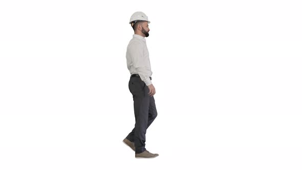 Businessman in Formal Wear and White Hardhat Walking on White Background alt
