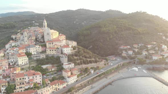 Aerial: flying around Cervo medieval town on the mediterranean coast, Liguria riviera, Italy alt