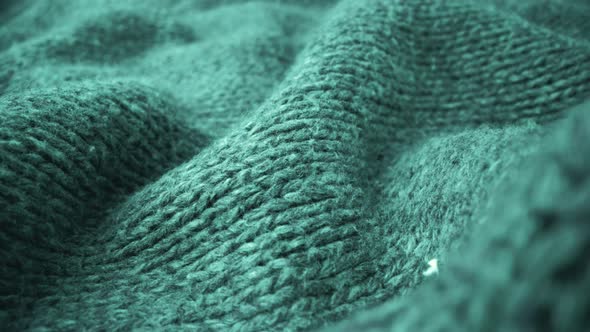 Extreme detail view of sheep wool cloth texture flowing in macro dolly shot. alt