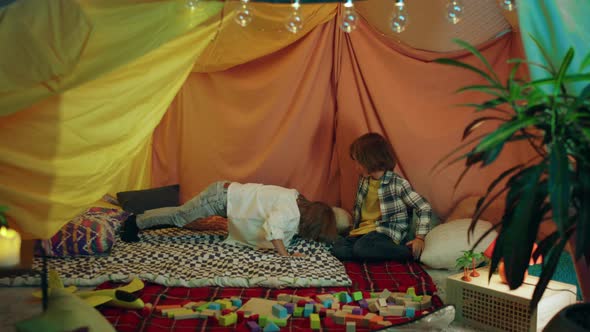 Two Little Boys are Hanging Out Inside a alt