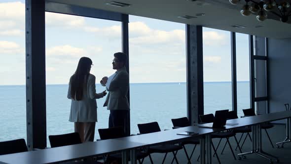 Financial Managers Discussing Contract at Panorama Window alt