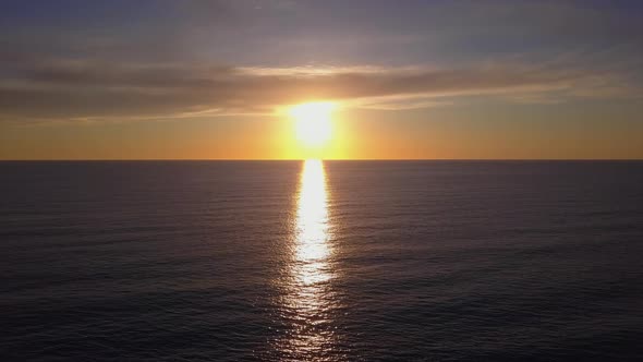 Aerial View Drone Flying Over Sea Surface in Evening Sun Light, Golden Hour Sunset, Cinematic Shot alt