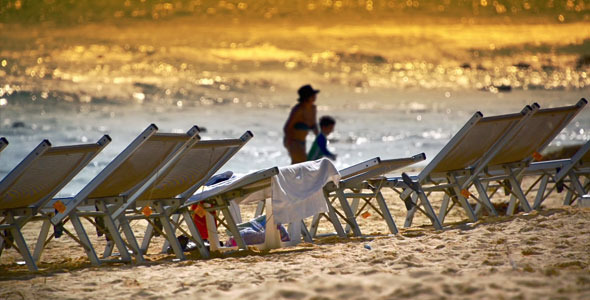 Sun Loungers Near To Sea At Beach Sunset