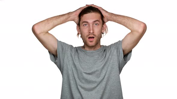 Portrait of Tall Guy in Panic Grabbing Head and Expressing Stress or Disbelief About Tense Situation alt