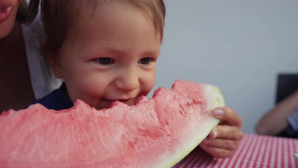 Young Mom with Daughter Eat Watermelon at Home alt