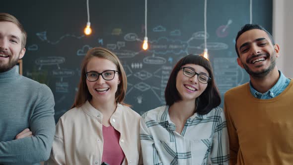 Slow Motion Portrait of Joyful Youth Men and Women Laughing in Creative Office alt