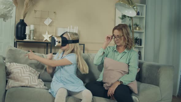 A Girl Is Playing with VRglasses While Being with Her Granny alt