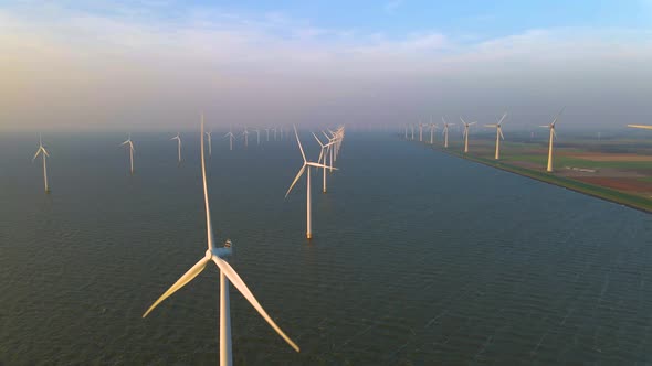 Wind Turbines in the Early Morning Wind Mill Park in the Netherlands alt