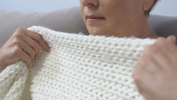 Close-Up of Senior Woman Covering in Scarf and Coughing at Home, Cold and Flu