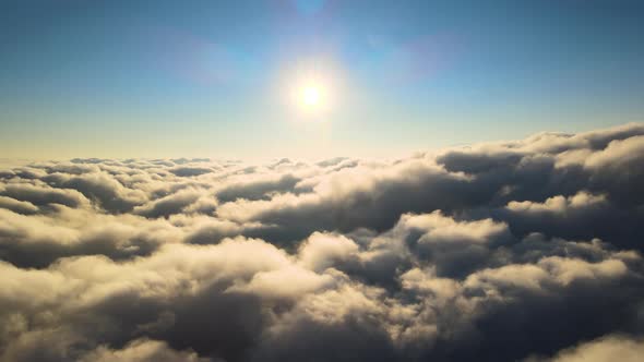 Aerial View From Airplane Window at High Altitude of Dense Puffy Cumulus Clouds Forming Before alt