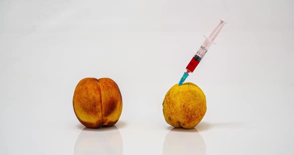 Time Lapse of Rotting Peach with a Syringe, the Concept of the Harm of Drug Addiction and the alt