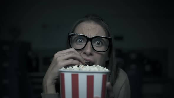 Woman watching horror movies at home