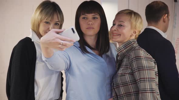 Woman Making Self Photo with Colleagues on Her Smartphone