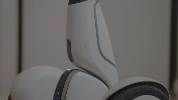 White Modern Gyro Scooter Gadget Stands in the Room and Keeps Balance Itself alt