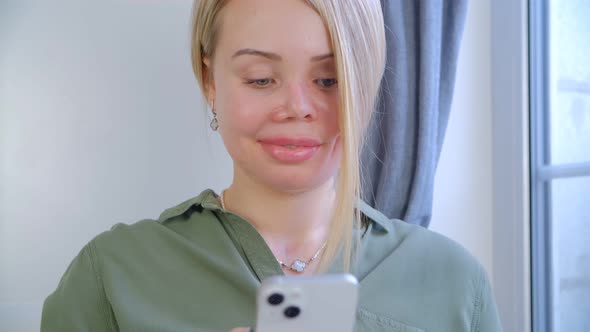 Domestic violence victim woman with prosthetic eye and scars using mobile phone app alt