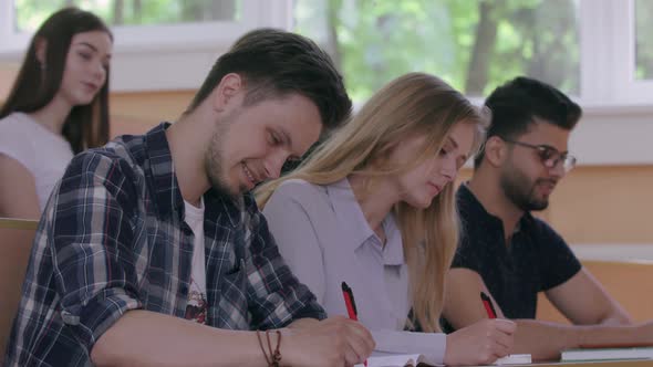 Attentive Students Writing Down the Summary of Lecture alt