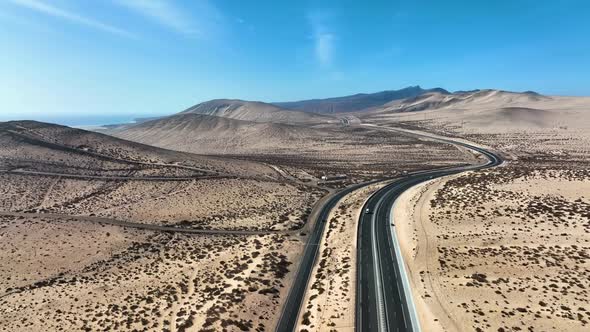 Top View Od a Curvy Road Across the Sandy Dunes of Fuerteventura Islands