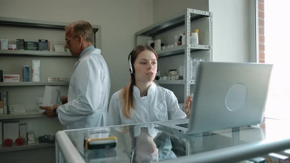 Woman Pharmacist in Headset Giving Task for Employee to Form Order in White Box alt
