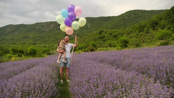Father and Daughter in Lavender Garden with Balloons