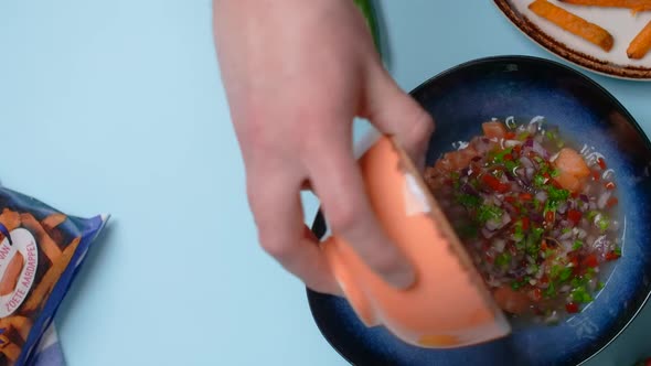 Vertical Food Video the Cook Mixes Chopped Salmon and Spicy Sauce for Making Tacos