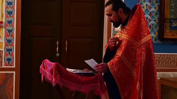 Orthodox Priest is Prays to Parishioners.