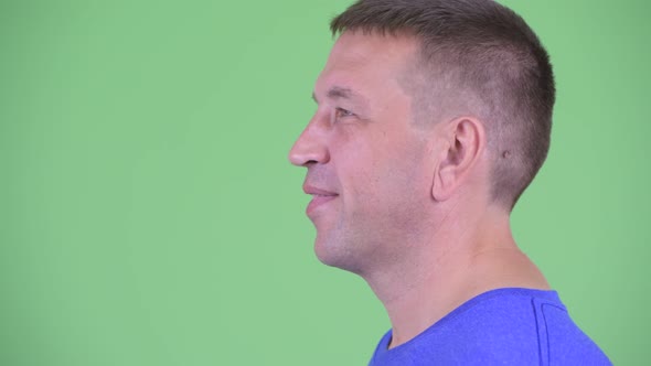 Closeup Profile View of Happy Macho Mature Man Smiling alt