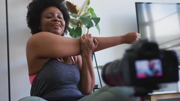 African american female plus size vlogger recording a video about working out alt