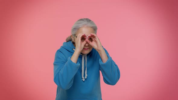 Nosy Curious Senior Granny Woman Closing Eyes with Hand Spying Through Fingers Hiding Peeping alt