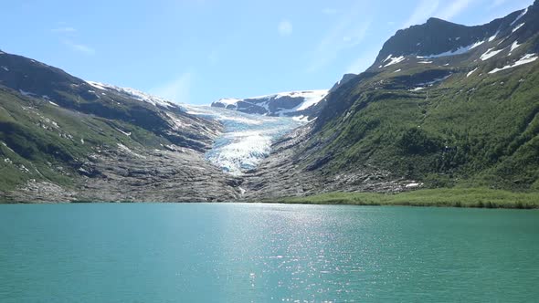 Lake Svartisvatnet in Helgeland in Norway, with Svartisen Glacier in the Background alt